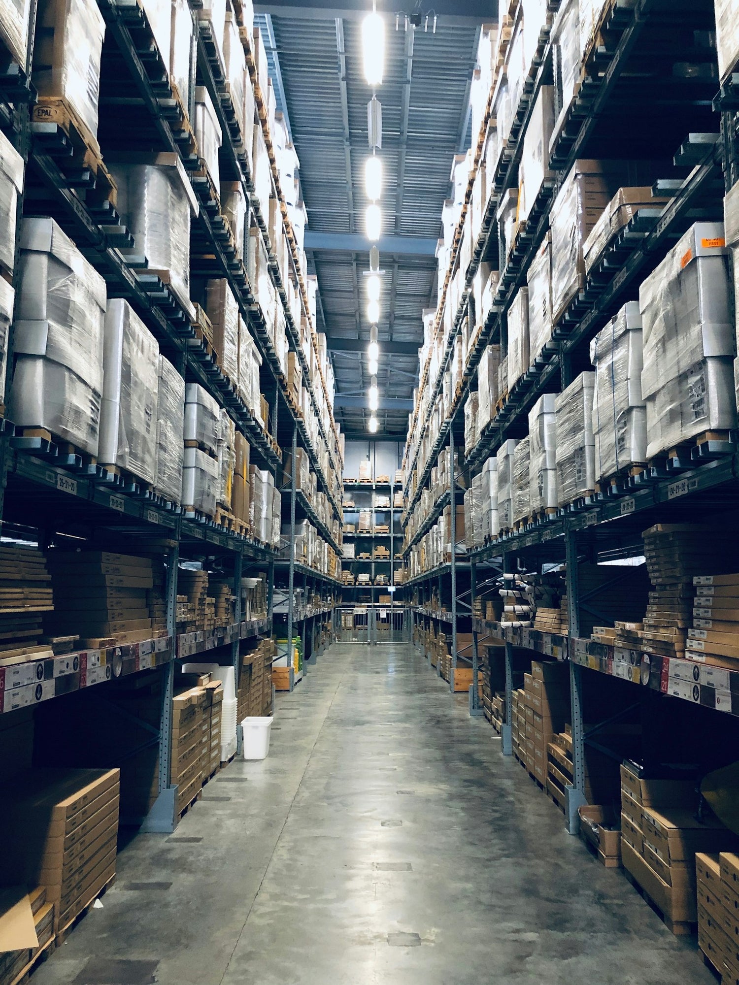 Warehouse worker inspecting industrial equipment
